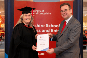Jo Leigh with the Dean of Uclan getting her certificate for making it on to the Dean's list.