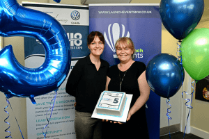 Jo Leigh and nichola Howard from Launch north west holding a cake to celebrate Leigh expo's 5th birthday