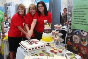 image shows the organisers of Leigh expo 2015 cutting a cake