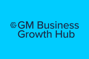 GM Business Growth Hub logo in dark blue displayed on a bright blue background.