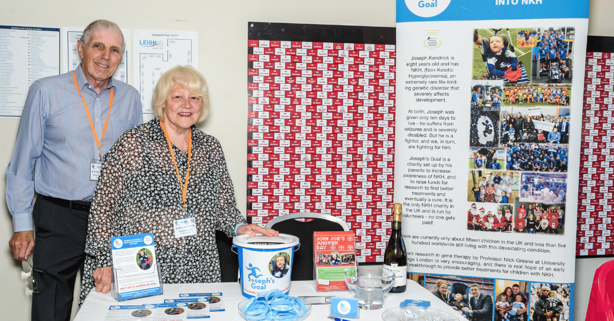 Norman and Ann Kendrick pictured with Joseph’s Goal at Leigh Business Expo in 2018