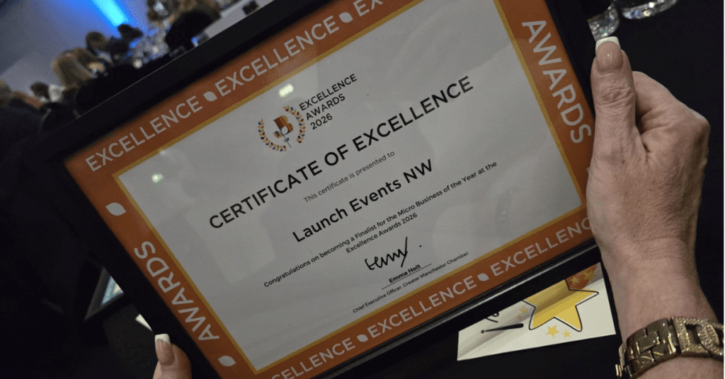 Close-up of a Certificate of Excellence from the Excellence Awards 2026, presented to Launch Events NW for becoming a finalist for Micro Business of the Year. The certificate is being held by a person at the awards event.
